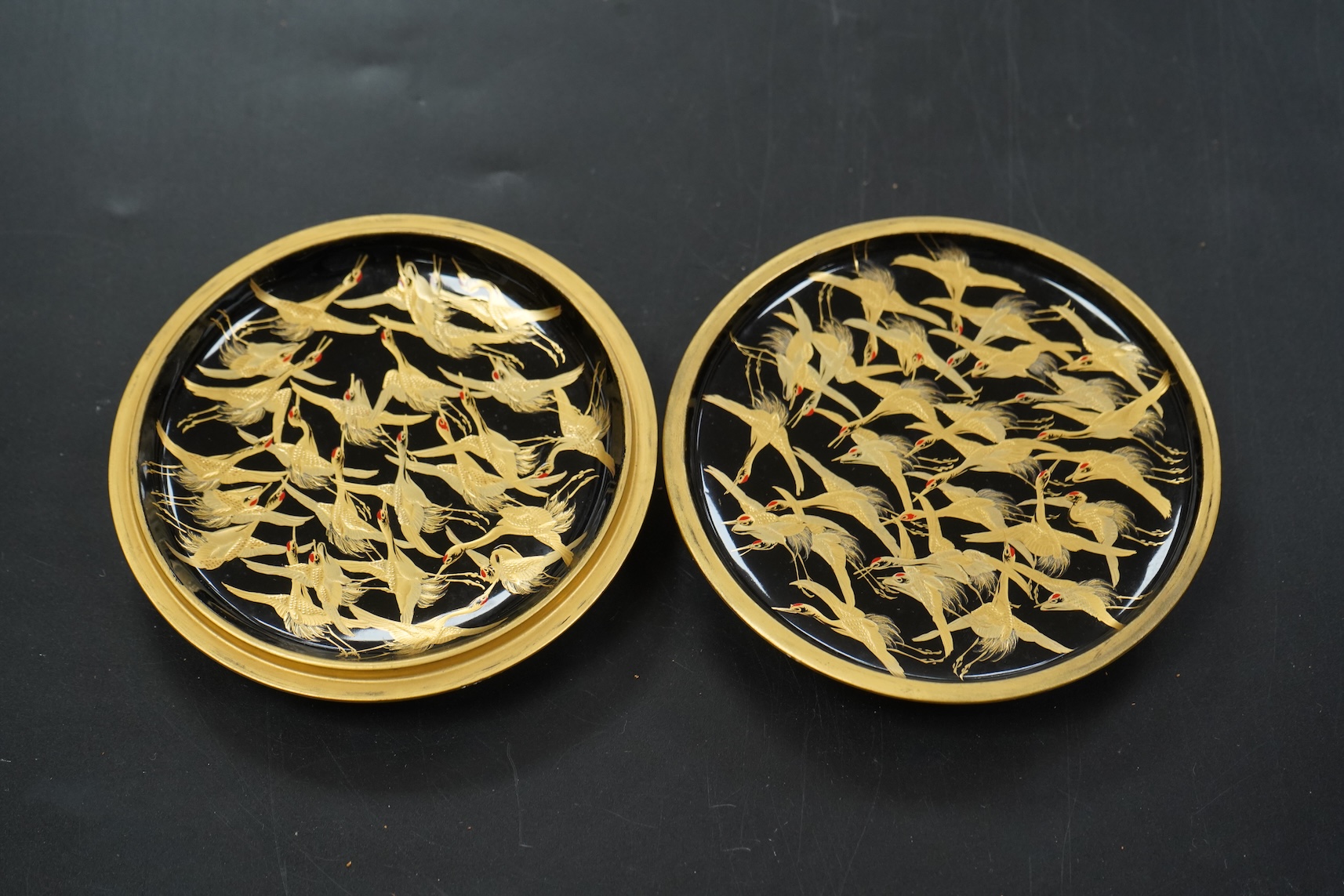 A Japanese circular gilt lacquer box decorated in relief, with paperwork, 10cm in diameter